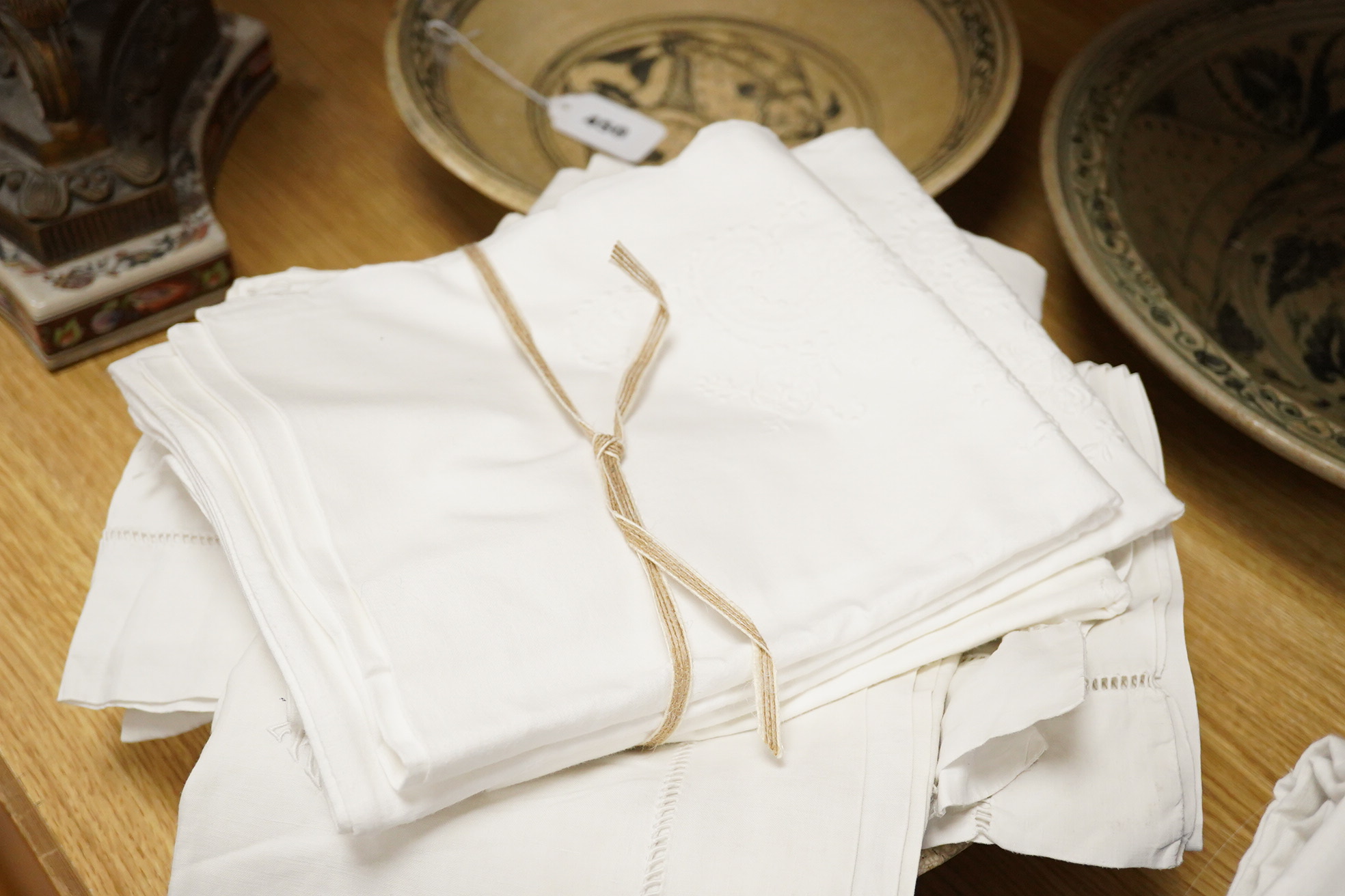 Two matching linen hand monogrammed sheets, one 216cm x 330cms, the other 212cm x 340 cms, together with three later monogrammed linen pillow cases and three embroidered cotton pillowcases.